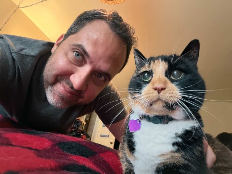 Felipe pets a cat named Jenn