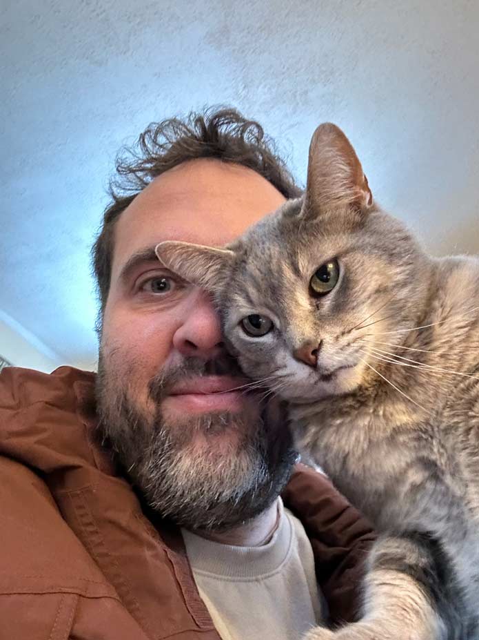 Felipe sitting a grey tabby cat