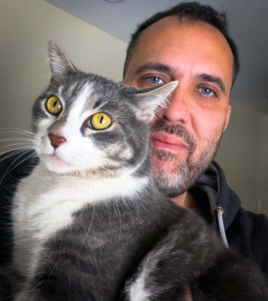 Felipe cat sitter with a grey cat in London, Ontario